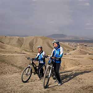L to R. Zakia Mohammadi (21) and Zahra Naarin (24) with their mountain bikes on a hilly range on the outskirts of Kabul. The two girls travelled from Bamiyan, in central Afghanistan, to Kabul to be interviewed and photographed. (Photograph by Andrew Quilty)