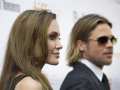 Brad Pitt and his wife Angelina Jolie pose for a photograph on the red carpet before the screening of this new movie "Moneyball" at the Toronto International Film Festival in Toronto on Friday, Sept. 9, 2011. The Hollywood power couple that was Brad Pitt and Angelina Jolie made a big mark on Canada.