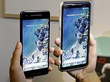 FILE - In this Wednesday, Oct. 4, 2017, file photo, a woman holds up the Google Pixel 2 phone, left, next to the Pixel 2 XL phone at a Google event at the SFJAZZ Center in San Francisco. The phones set themselves apart with promises to bake in Google's powerful artificial-intelligence technology for quick and easy access to useful, even essential information. You get some of that right away, but more will come later through free software updates and a wireless accessory. (AP Photo/Jeff Chiu, File)